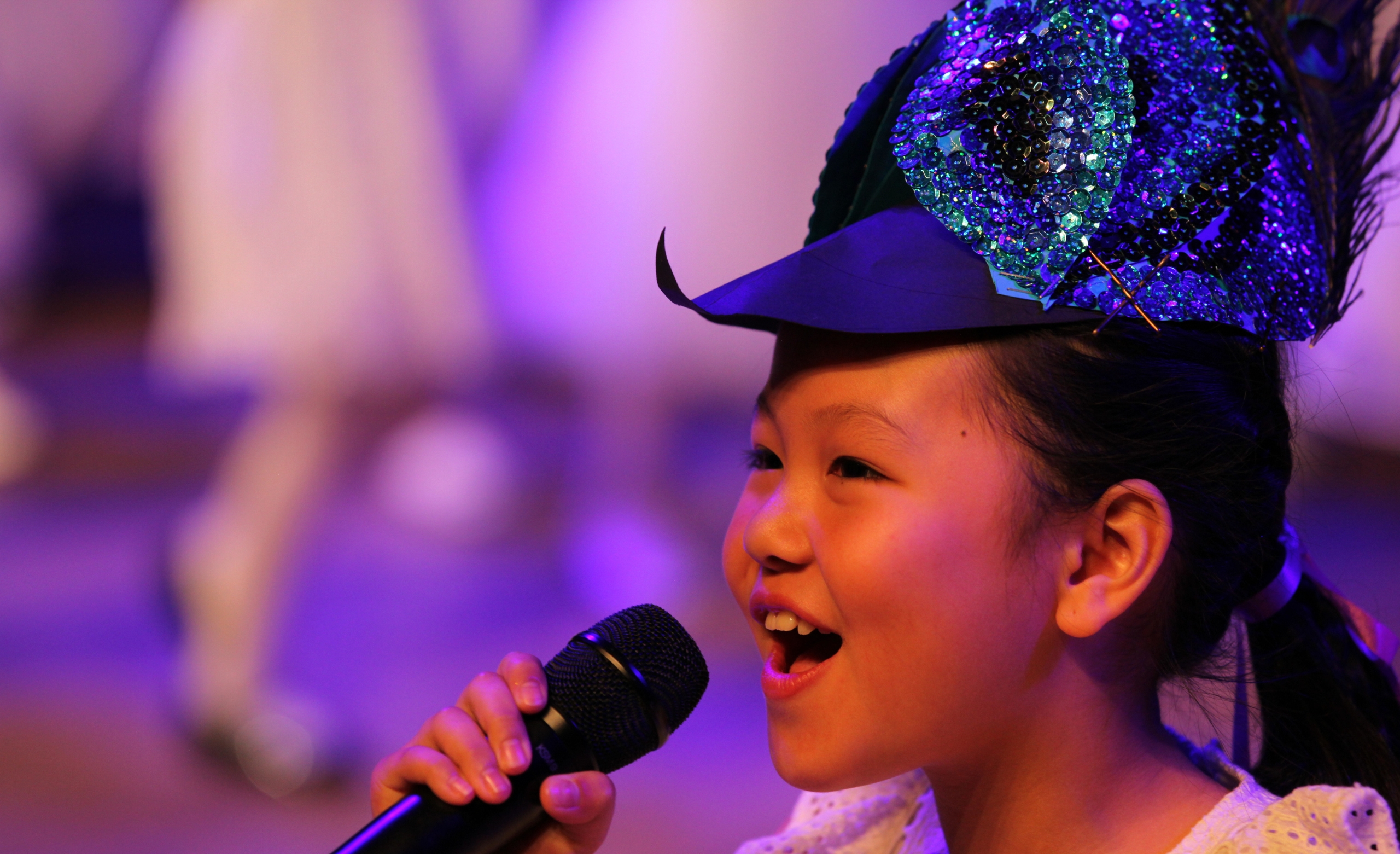 Girl performing with sequin blue hat