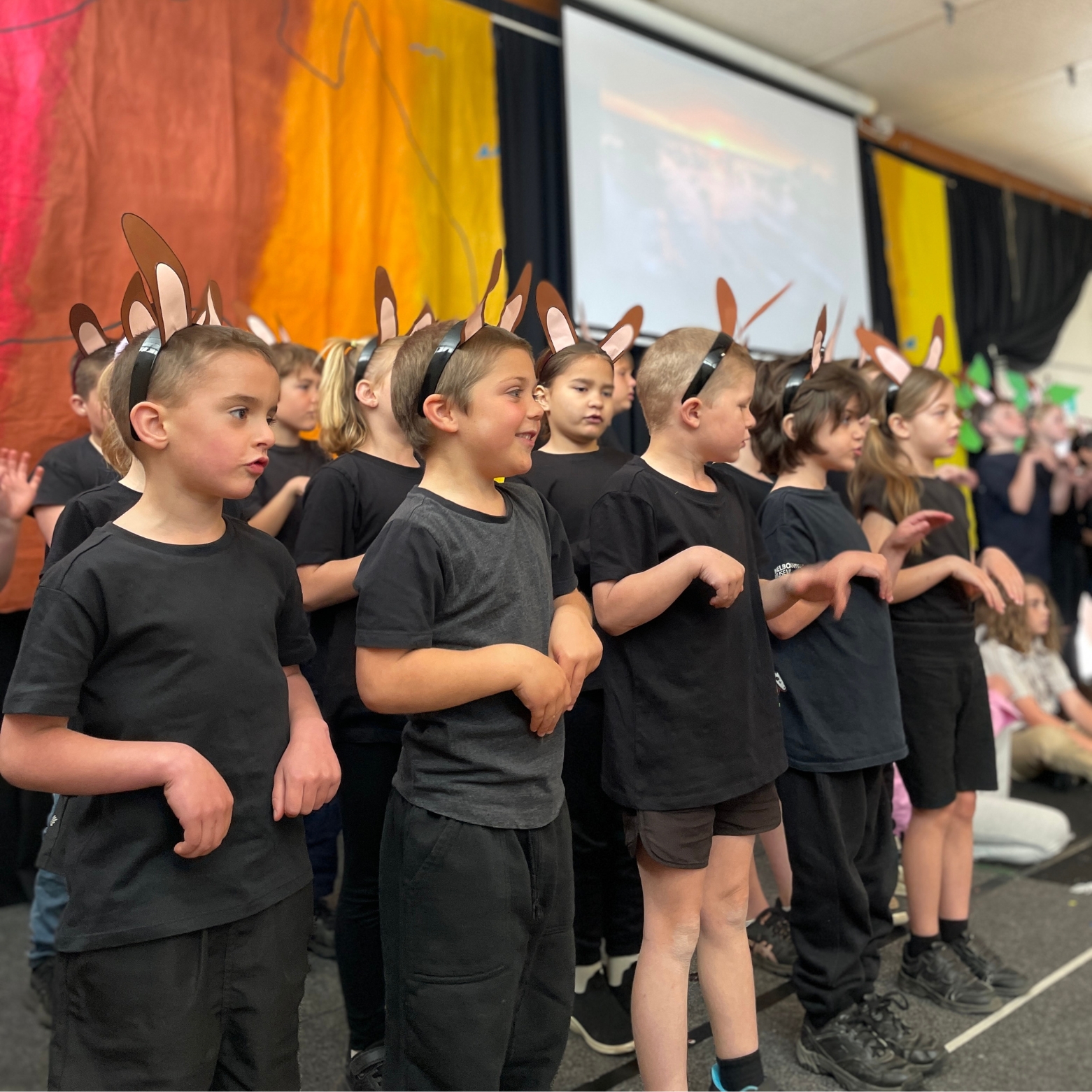 A group of boys perform on stage as Kangaroos during an Aussie Adventure Musical