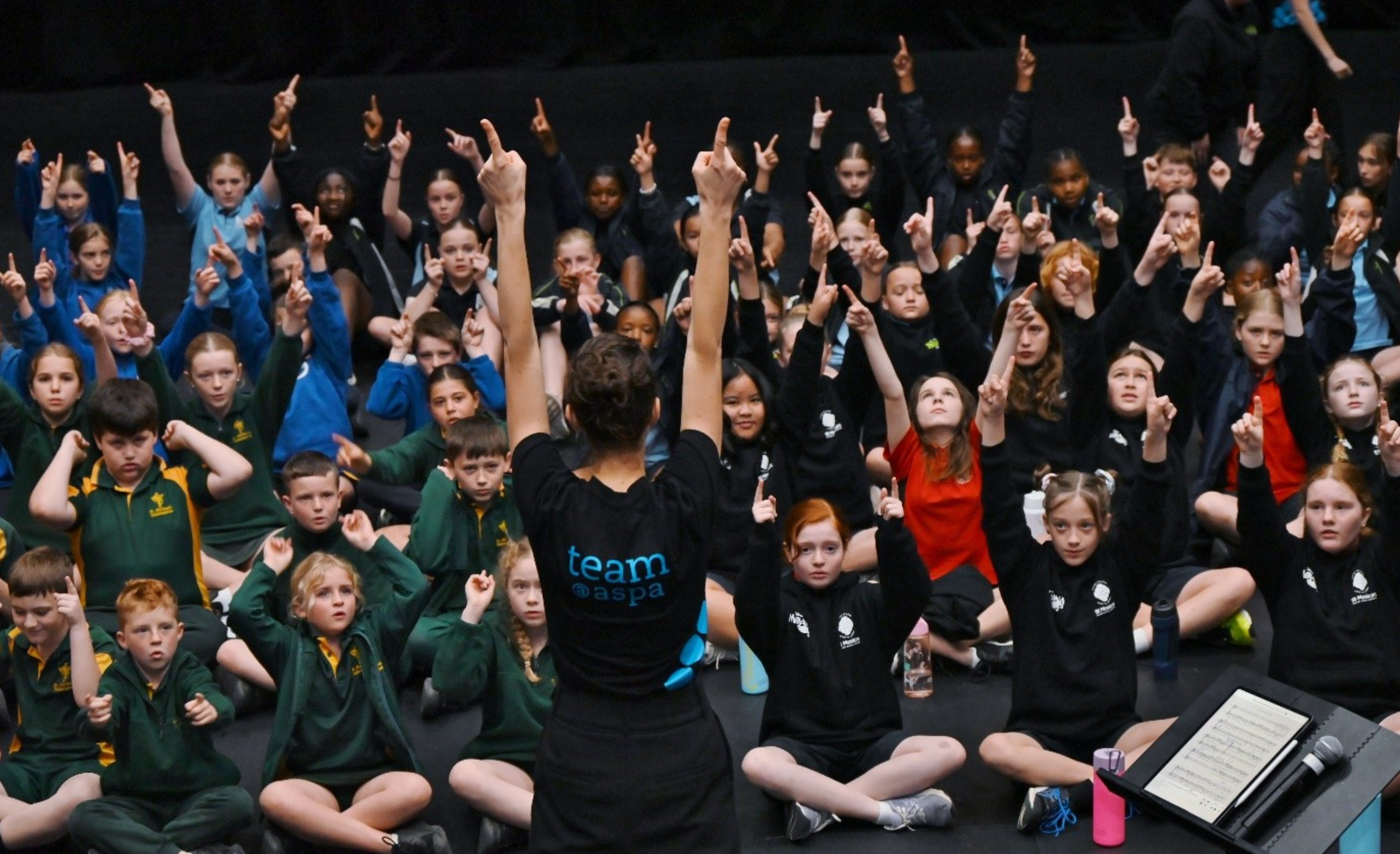 ASPA ed staff teaching school children in uniform