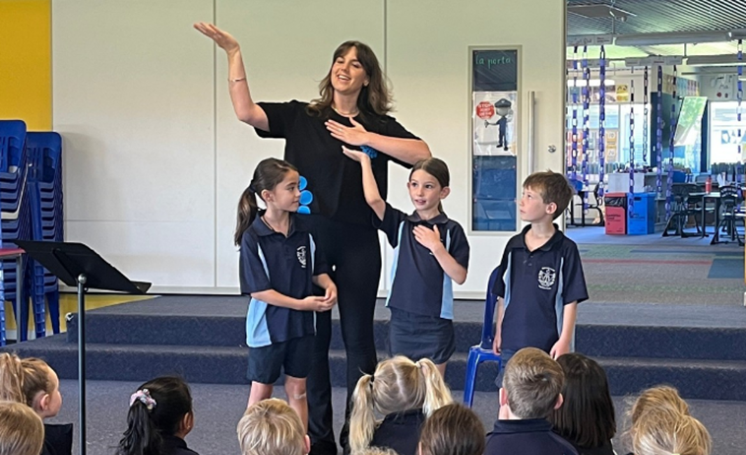 tutor teaching dance routine to student in school uniform