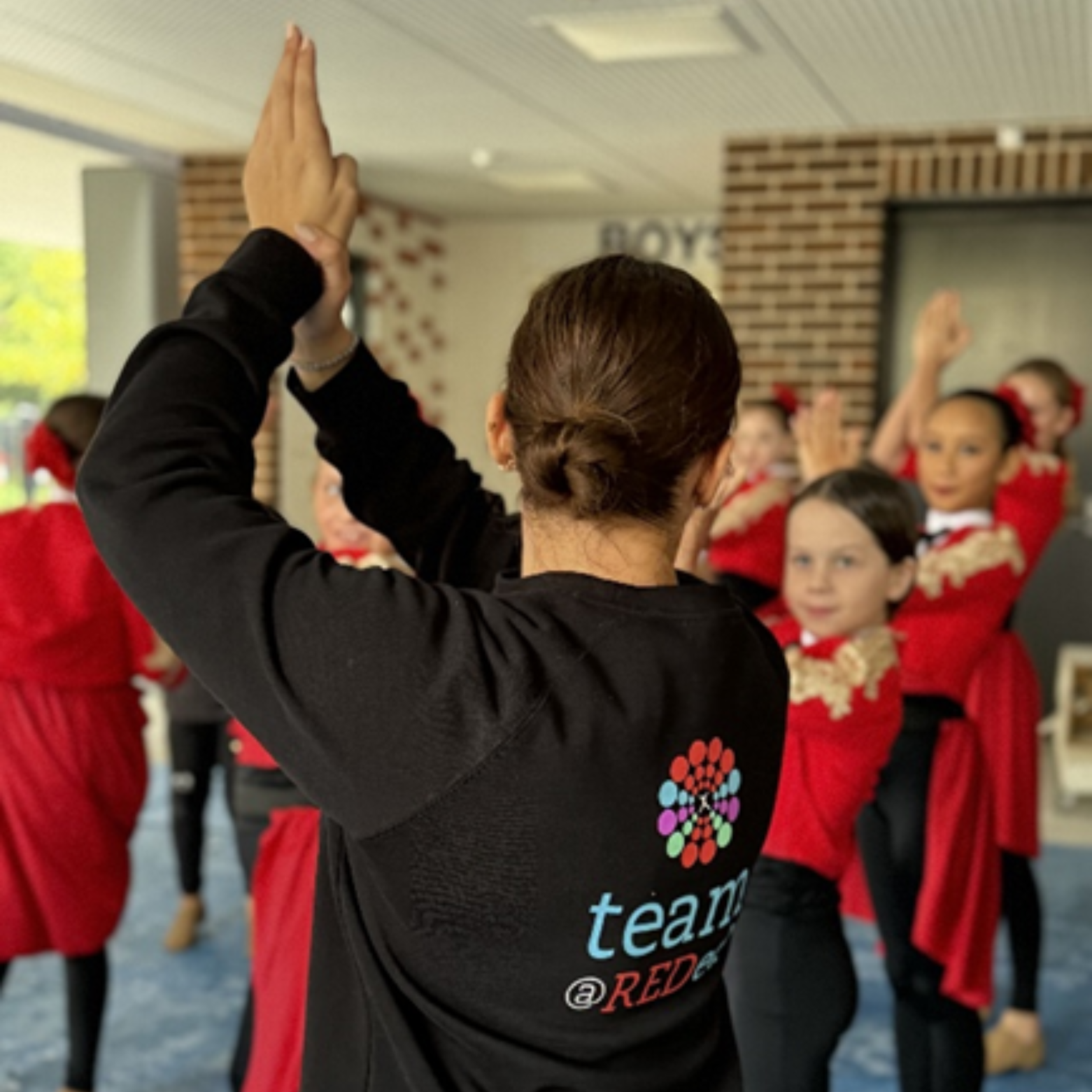 dance instructor teaching students in uniform